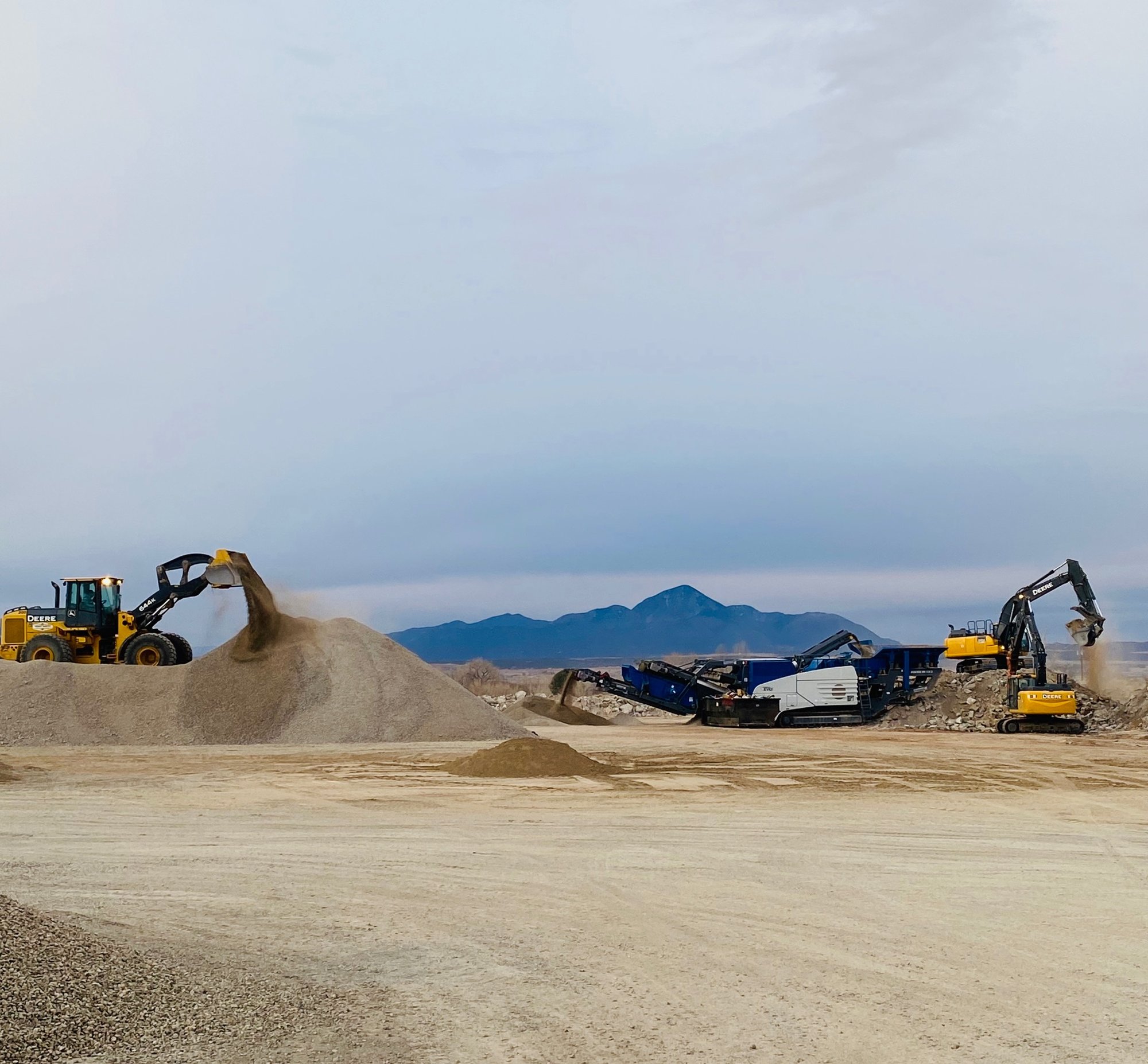 Loaders and a crusher working aggregate at the Smith's Materials yard